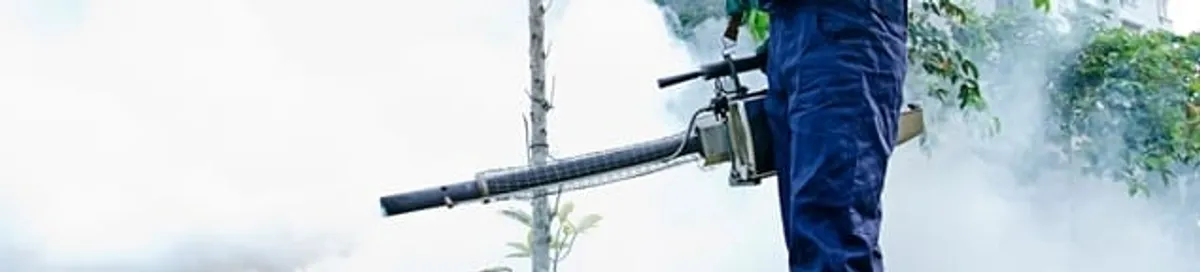 Pest control technician fogging an outdoor area for insect control in Fort Worth, TX