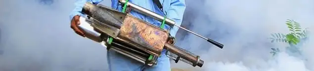 Fumigation technician using a fogger for deep pest treatment in Fort Worth, TX