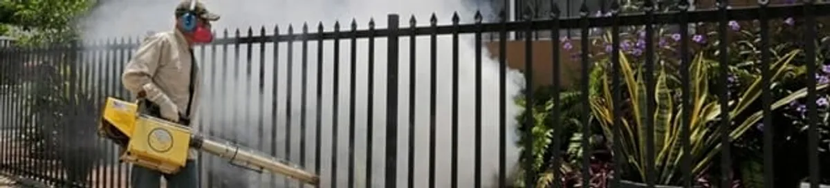 Mosquito control technician fogging a yard perimeter for mosquito reduction in Fort Worth, TX